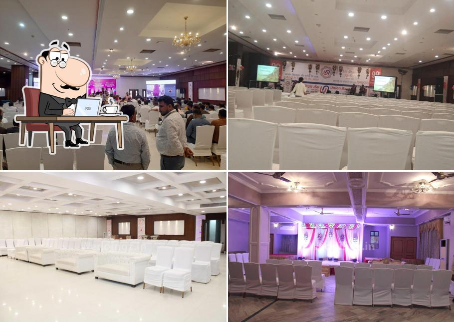 Take a seat at one of the tables at Hotel Surabhi International