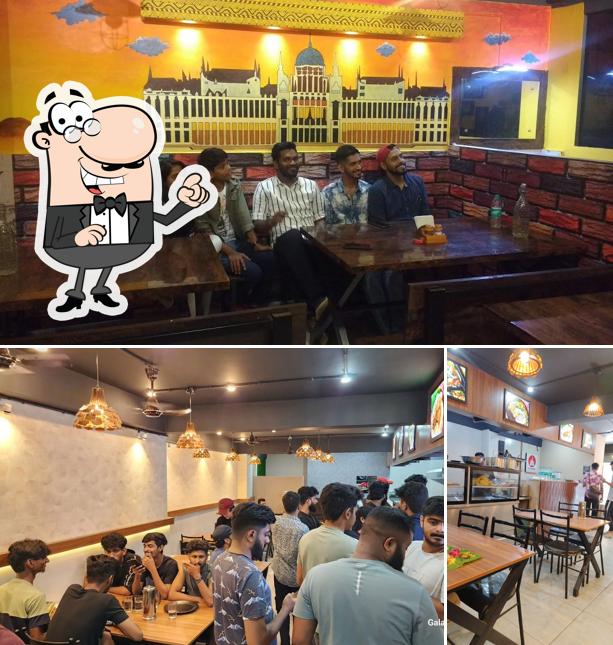 Take a seat at one of the tables at Kottaram restaurant Bangalore