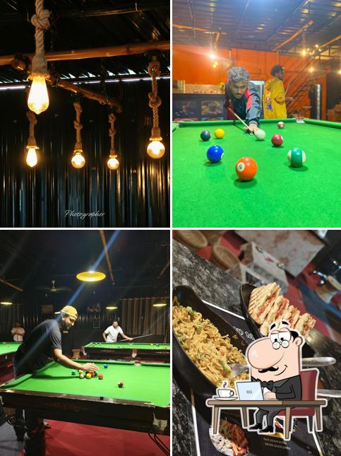 Take a seat at one of the tables at Night Walkers Snooker club & cafe