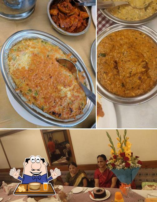 Take a look at the image displaying food and dining table at Tapti Restaurant