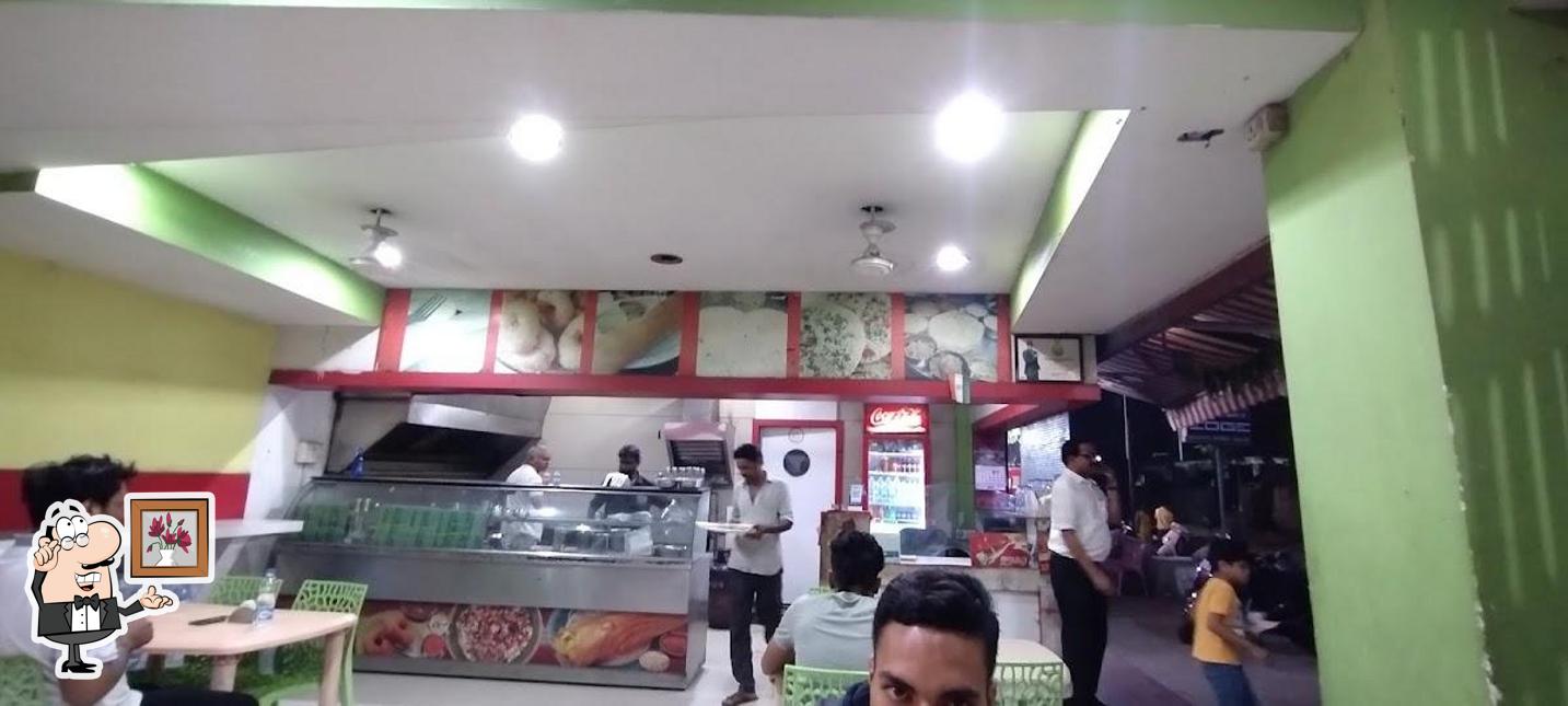 Take a seat at one of the tables at Roothraj Dosa Center