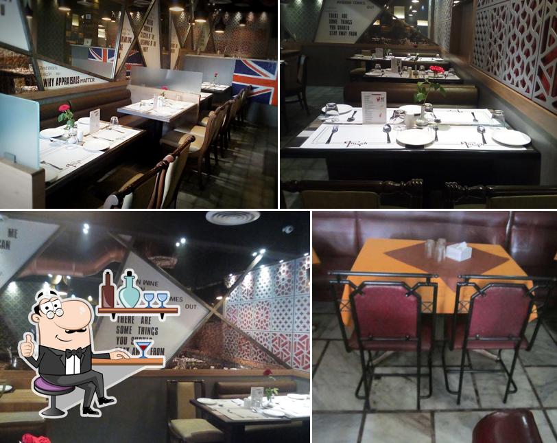 Take a seat at one of the tables at Aruna Palace Bar & Restaurant