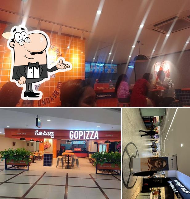 Take a seat at one of the tables at GOPIZZA Garuda Mall