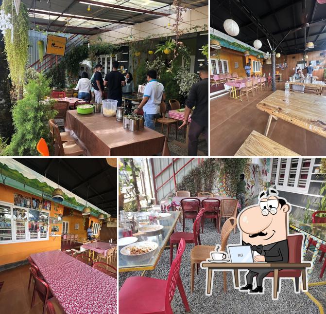 Take a seat at one of the tables at TUSKER CAF'E Restaurant Thekkady