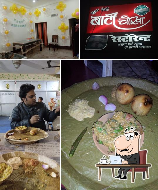 Take a seat at one of the tables at Batti chokha Restaurant