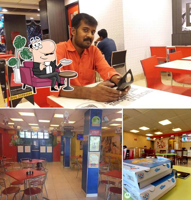 Take a seat at one of the tables at Domino's Pizza Cantonment, Tiruchirapalli
