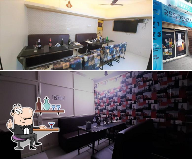 Take a seat at one of the tables at 7 Eleven A/C Bar, SJK Hotel Sri Dhevi Salem