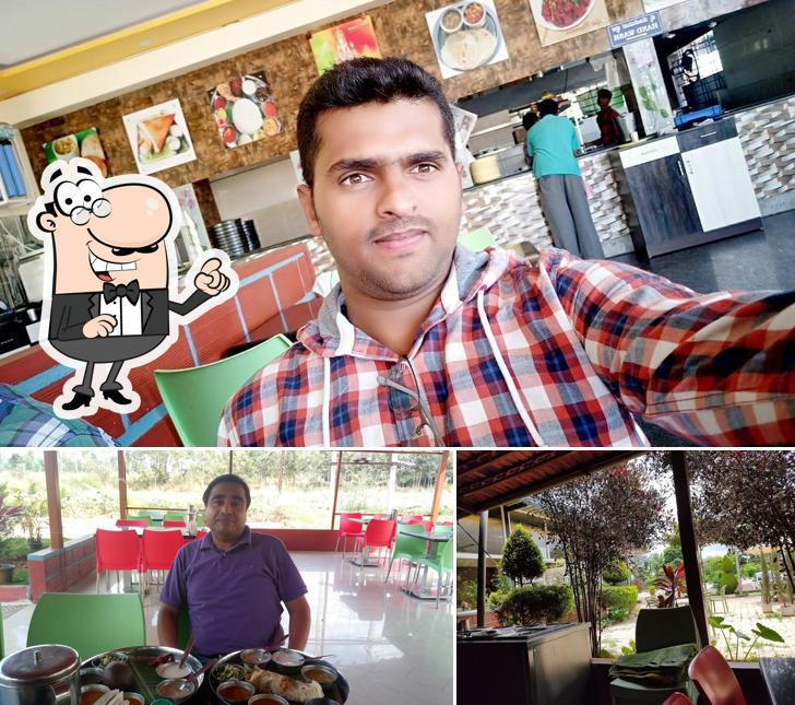 Take a seat at one of the tables at Nandhi Garden Hotel