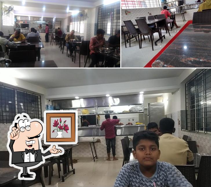 Take a seat at one of the tables at SAILEELA VEG RESTAURANT