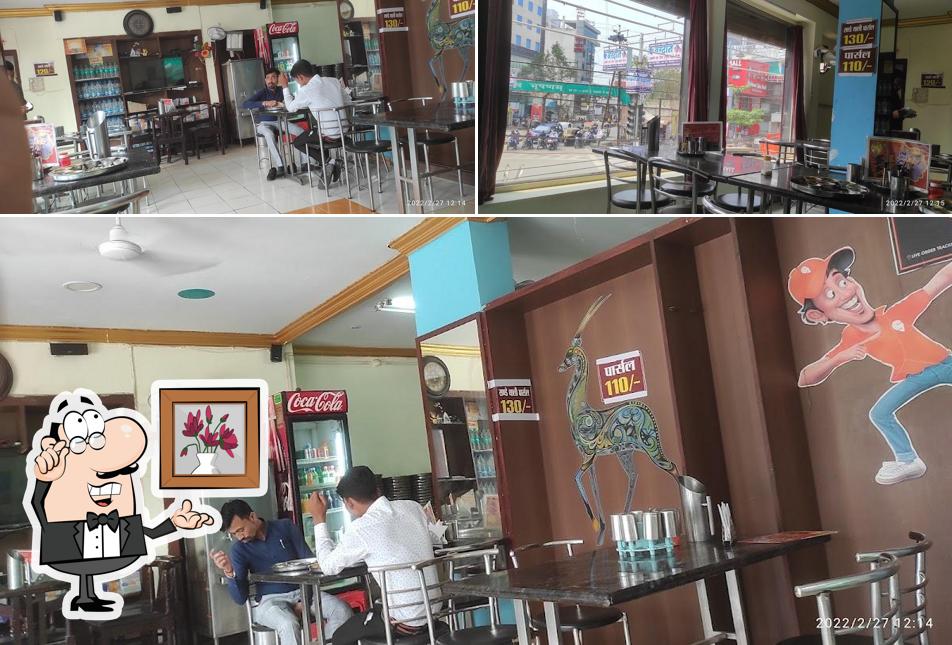 Take a seat at one of the tables at New Santusht Thali Restaurant