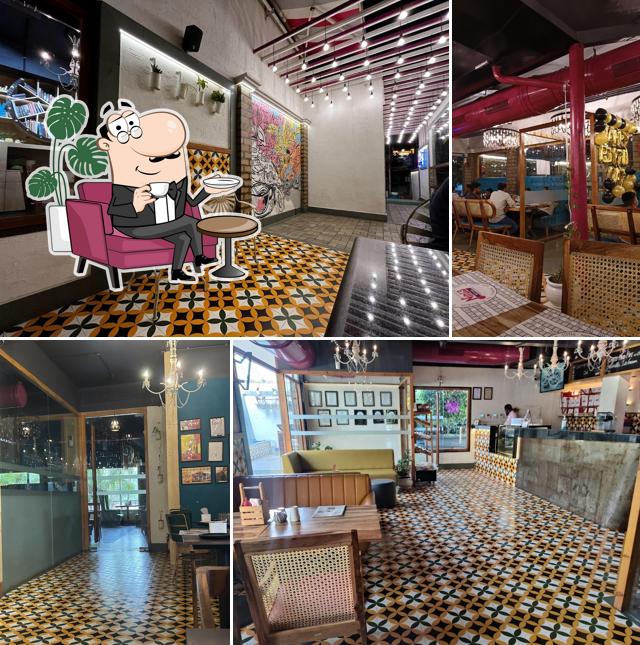 Take a seat at one of the tables at Nini's Kitchen - (V V Nagar)