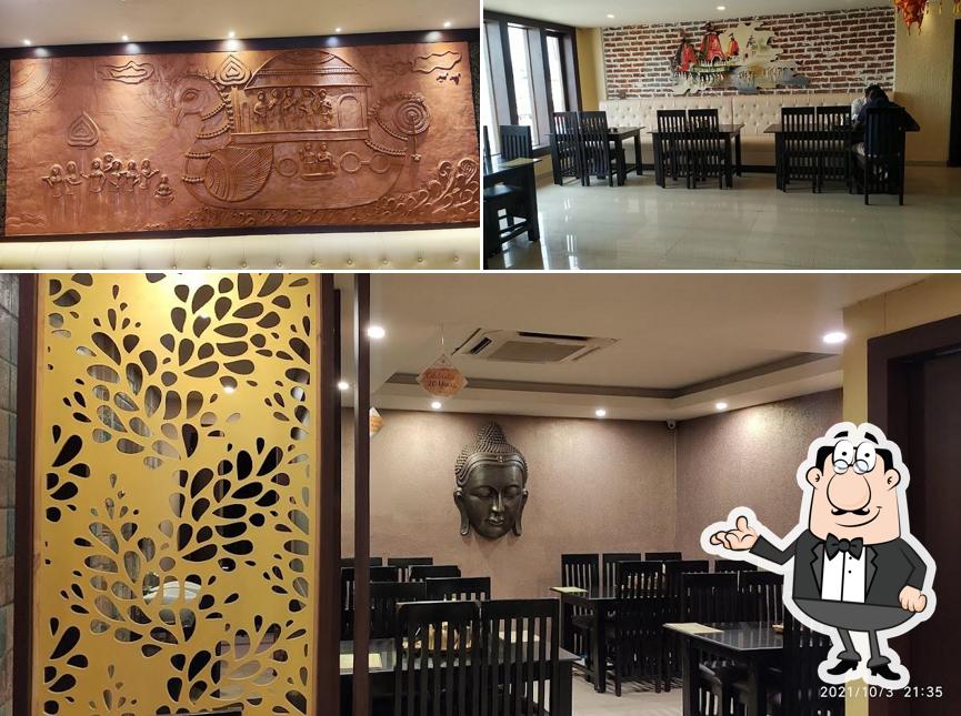 Take a seat at one of the tables at Odisha Hotel