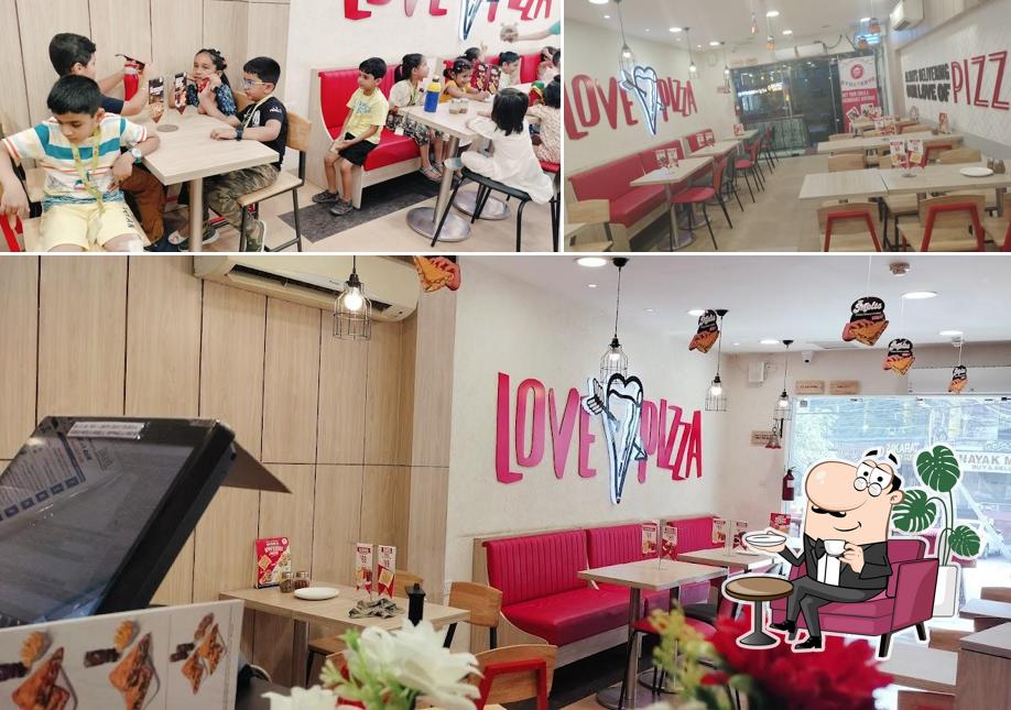 Take a seat at one of the tables at Pizza Hut Lajpat Nagar, New Delhi