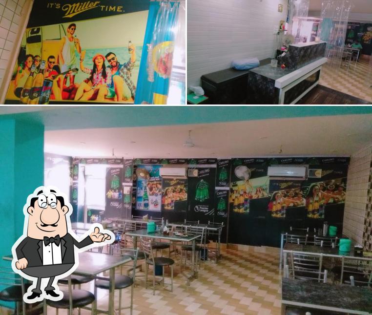 Take a seat at one of the tables at Jass Fish And Chicken Corner