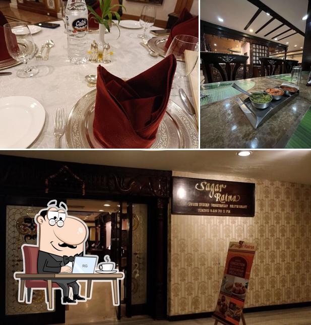 Take a seat at one of the tables at Sagar Ratna Restaurant, Ashoka Hotel