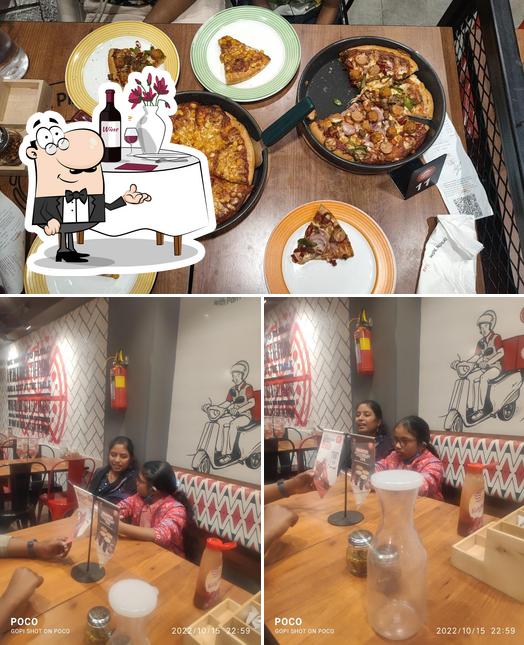 This is the image displaying dining table and food at Pizza Hut Gottigere, Bangalore