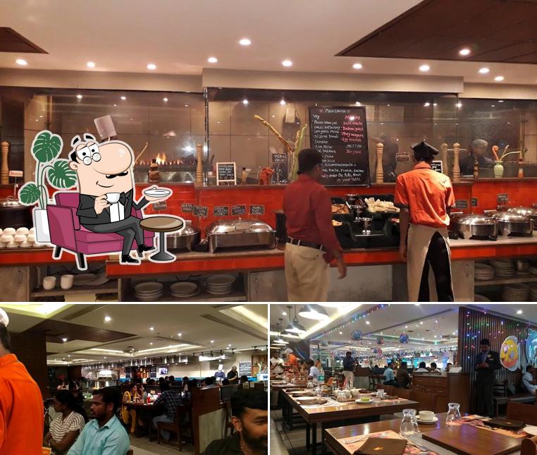 Take a seat at one of the tables at Barbeque Nation- T Nagar