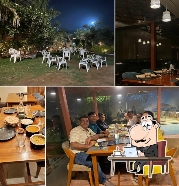 Take a seat at one of the tables at AANGAN GARDEN RESTAURANT