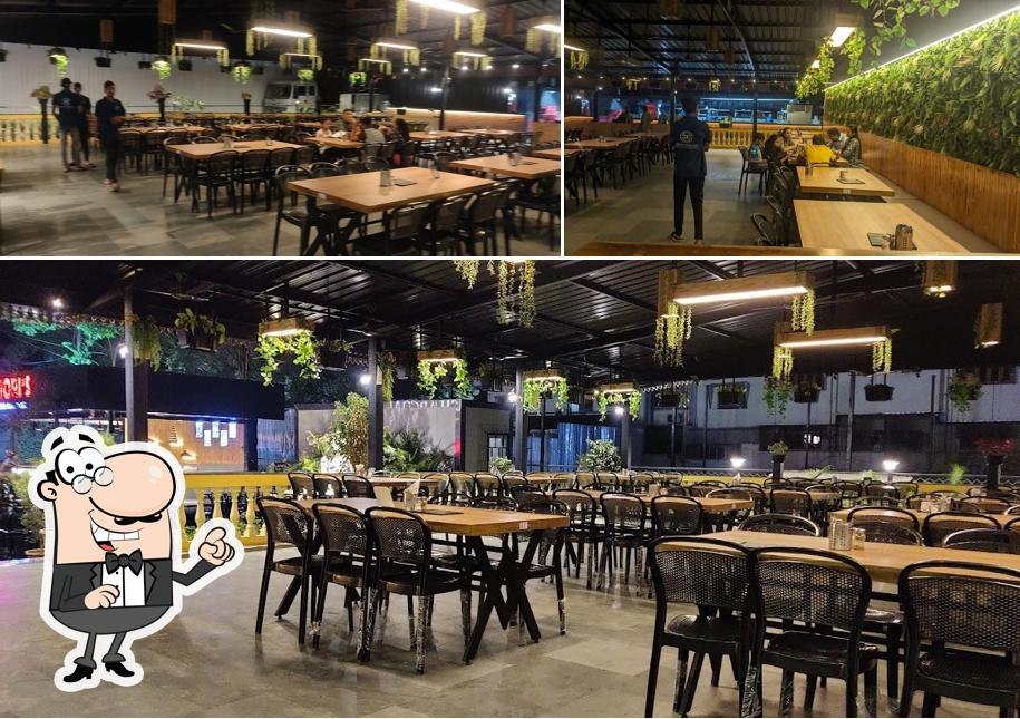 Take a seat at one of the tables at Dosa Charcoal - The Garden Restaurant