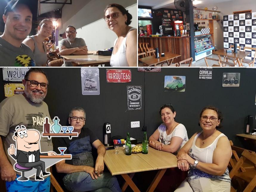 Sente em uma das mesas no Empórium Lima Petiscaria