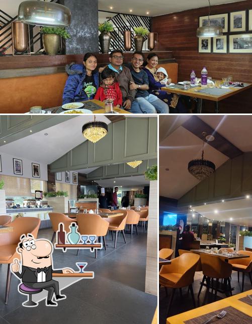 Take a seat at one of the tables at Grains Pure Veg by Udaan Nirvana, Darjeeling