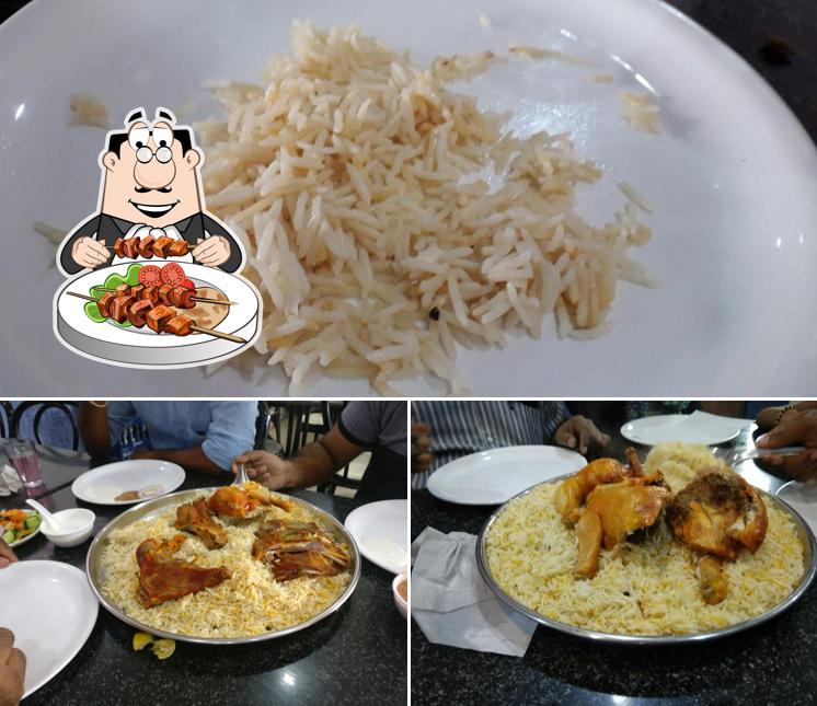 Among various things one can find food and dining table at Madhbi Hotel