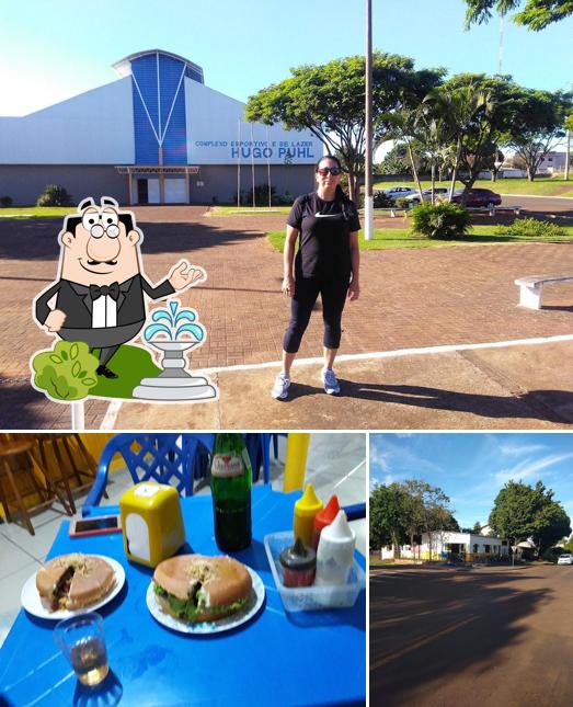 A ilustração do Galletos Lanches’s exterior e mesa de jantar