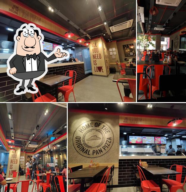 Take a seat at one of the tables at Pizza Hut Alagapuram, Salem