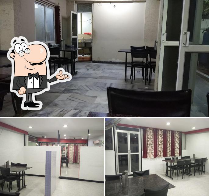 Take a seat at one of the tables at New Deccan Bawarchi Restaurant