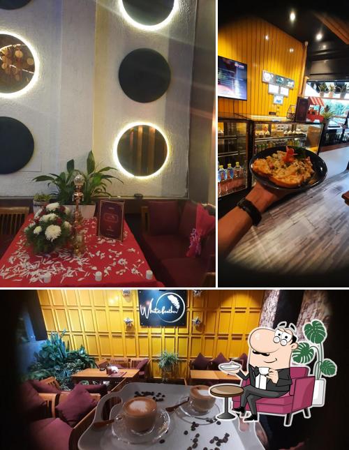 Check out the picture displaying interior and beverage at White Feather Panipat