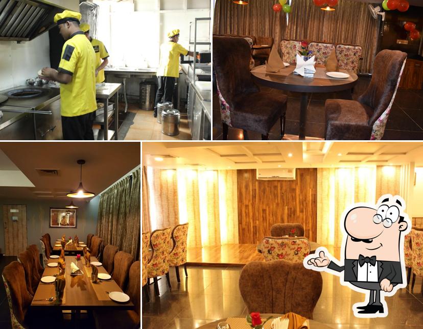 Take a seat at one of the tables at Mezbaan Fine Dine Restaurant