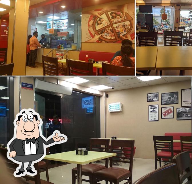 Take a seat at one of the tables at Domino's Pizza Koonamthai, Edappally