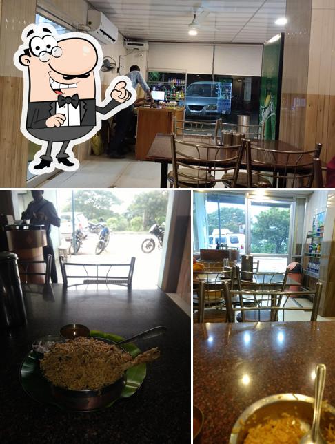 Take a seat at one of the tables at Naatukozhi Biriyani Kadai
