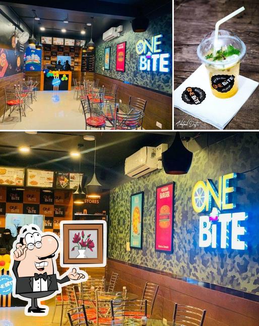 Take a look at the image showing interior and beverage at One Bite - A Family Restaurant