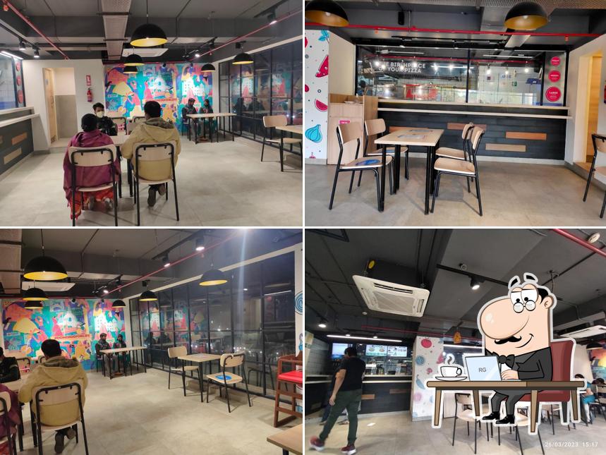 Take a seat at one of the tables at Domino's Pizza Kadamkuan, Patna