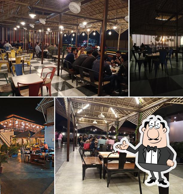 Take a seat at one of the tables at આપના અડ્ડા