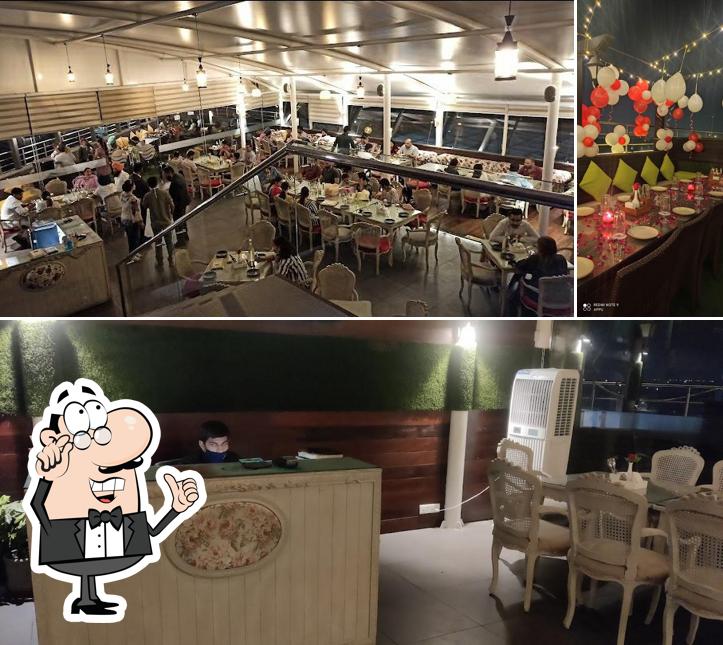 Among different things one can find interior and dining table at Sky Lounge Cafe' & Restaurant