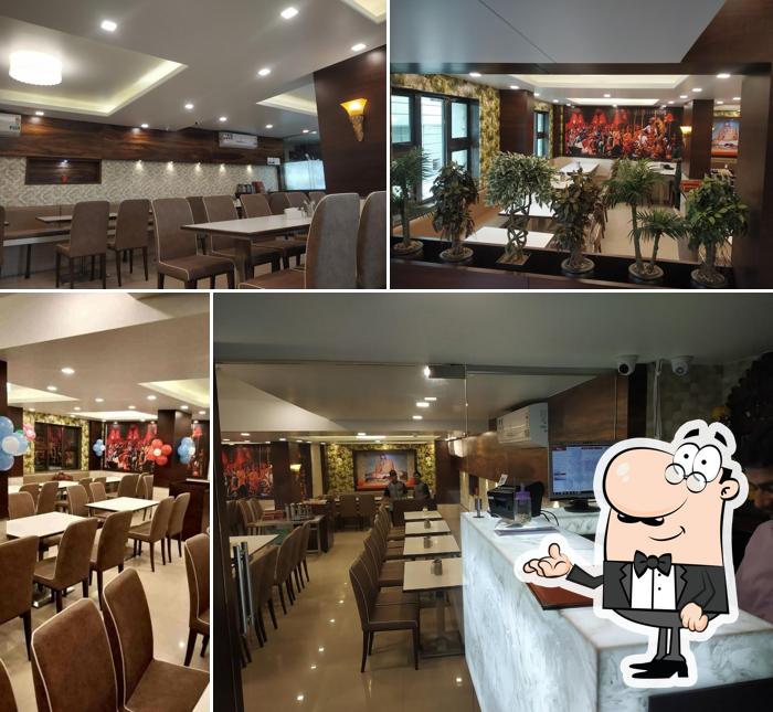 Take a seat at one of the tables at Shreeji Pure Veg - Narhe