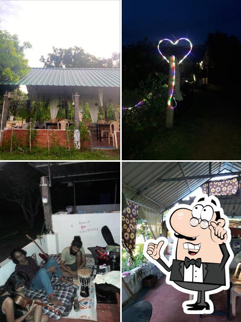 Take a seat at one of the tables at Uyir Together Cafe & Traveller Hostel