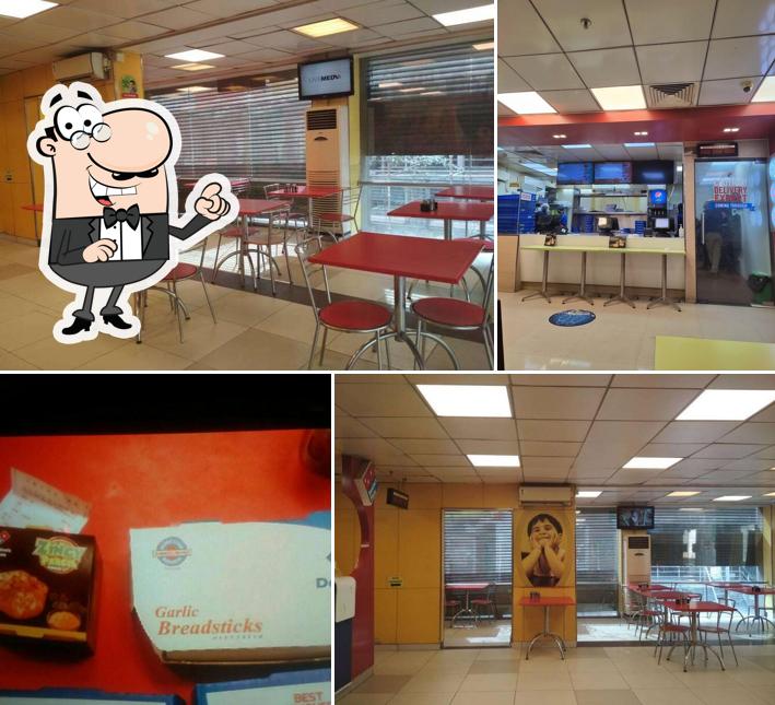 Take a seat at one of the tables at Domino's Pizza Sector 63, Noida