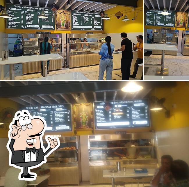 Take a seat at one of the tables at Shrii Vandhanam Fine Veg Restaurant