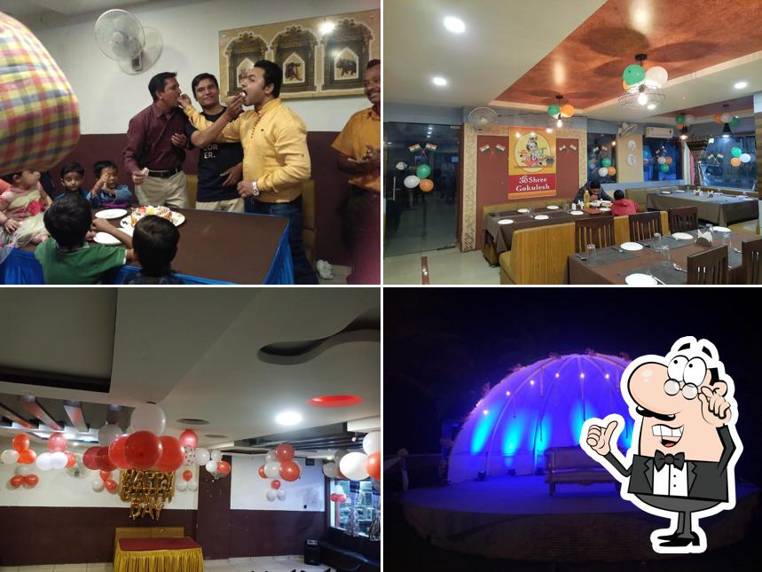 Take a seat at one of the tables at Om Shree Gokulesh Kathiyawadi and Punjabi Restaurant