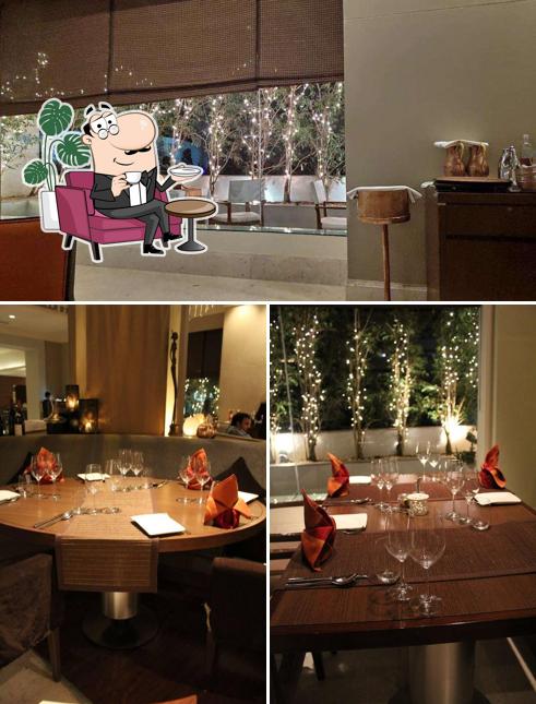 Take a seat at one of the tables at Saffron - Radisson Blu Bengaluru