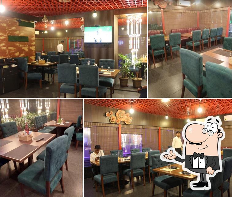 Take a seat at one of the tables at Silver Plate Restaurant Hardik Palacio Luxa Varanasi