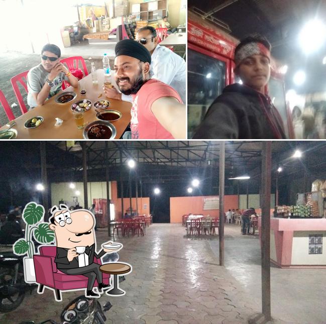 Take a seat at one of the tables at Hotel Ambika