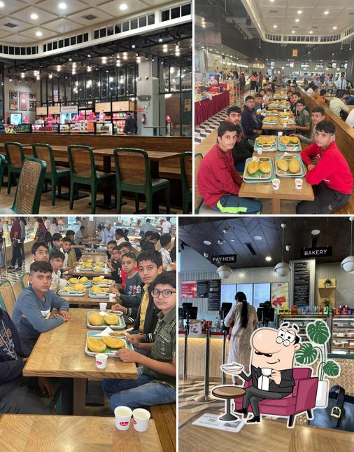 Take a seat at one of the tables at Haldiram's - Gajraula