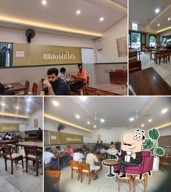 Take a seat at one of the tables at AMBHIKA Hotel