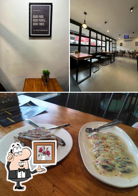The photo of interior and dining table at Waffee House Payyannur