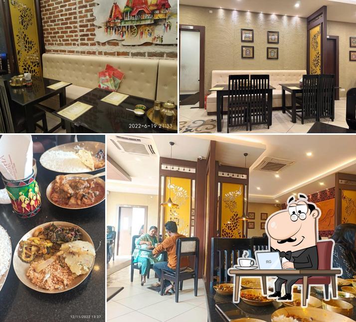 Take a seat at one of the tables at Odisha Hotel