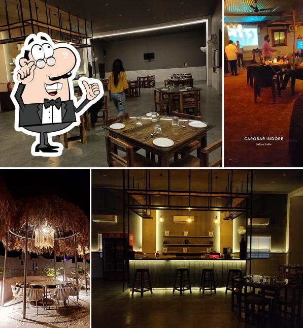 Take a seat at one of the tables at CaroBar - Multicuisine Restaurant Bar Cafe